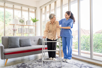 Asian women are being cared for by nurses who monitor health and physical therapy for elderly women living alone at home. by walking on a cane or using muscles