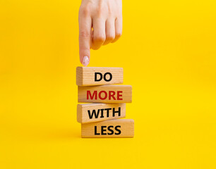 Do more with less symbol. Concept words Do more with less on wooden blocks. Beautiful yellow...