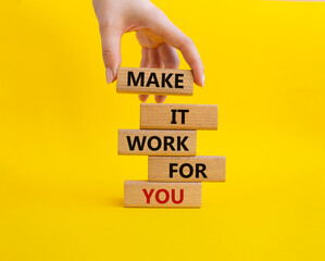 Make it work for you symbol. Business Concept words Make it work for you on wooden blocks. Beautiful yellow background. Businessman hand. Business concept. Businessman hand. Copy space