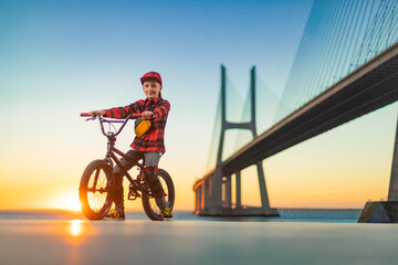 BMX Tricks For Beginners. A teenager bike racing rider in a skate park on a pump track.