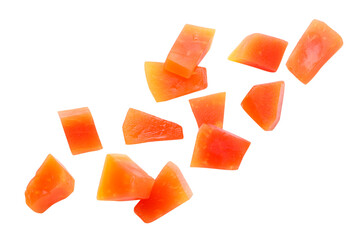 Pieces of canned papaya fly on a white background.