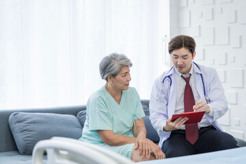 Asian doctor talking to patient with smile to encourage patients at the hospital