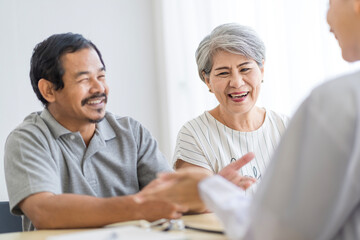 Asian seniors who are healthy, in a good mood, smiling, talking with financial or life insurance staff to take care of life after retirement.