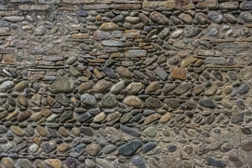 Stone wall. Ancient architecture. Old Europe. Stone background. French village. Background from an ancient stone wall
