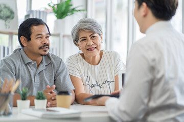 Asian seniors who are healthy, in a good mood, smiling, talking with financial or life insurance staff to take care of life after retirement.