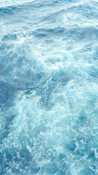 vertical footage of cruise sailing in the wind through the waves. sailing boat shot on rough blue sea at full speed while the sea is passing by.
