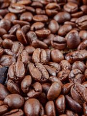 Antique vintage retro bronze coffee mill on black wooden board with roasted coffee beans     