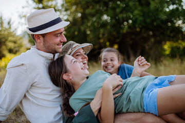 Happy lying and hugging on a medow, resting after hiking in nature.