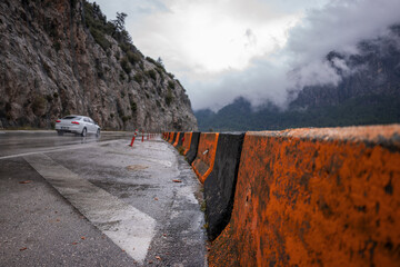 Beautiful and dangerous road, median and mountain by the lake