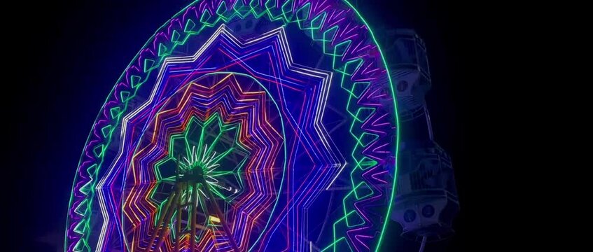 colorful lights decorate the amusement park at night