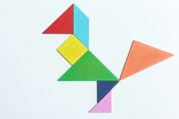 color tangram puzzle in bird shape on white background	
