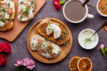 Aesthetic breakfast for Keto diet - sandwiches with greens, poached egg, salmon, spread, cream and zucchini sauce, coffee cup. Low in calories, FODMAP diet, superfood