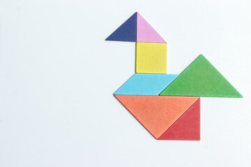 color tangram puzzle in bird shape on white background	