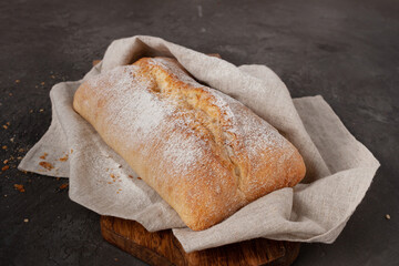 chibatta on a wooden board in a linen napkin, copy space