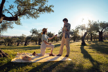 proposal marriage kneeling ring couple Lgbt lesbian women surprise in nature having picnic