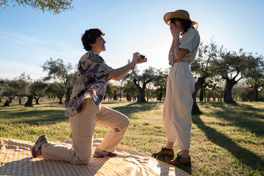 proposal marriage kneeling ring couple Lgbt lesbian women surprise in nature having picnic