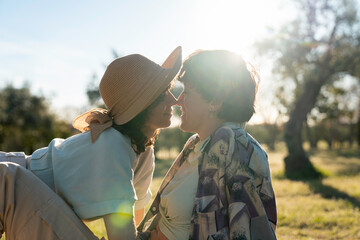 Girls kiss romantic couple LGBT lesbian outdoor nature picnic sunset