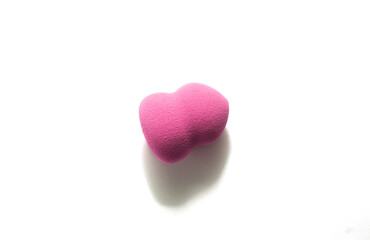 Pink makeup sponge on a white background. Means for applying professional make-up