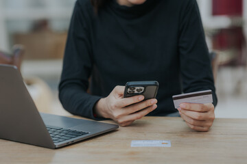 Close up of woman hand holding credit card online payment.