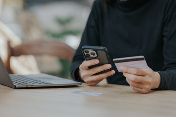 Close up of woman hand holding credit card online payment.