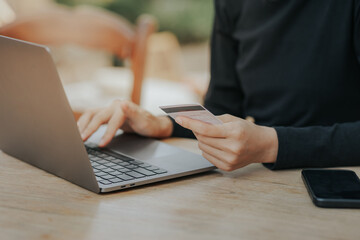 Close up of woman hand holding credit card online payment.