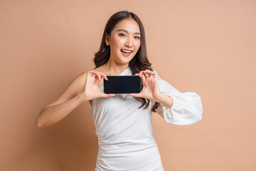 Naklejka premium carefree business smart attractive asian woman in well dress hand showing present blank smartphone to camera portrait shot,cheerful asia female holding smartphone laugh smile friendly warm welcome