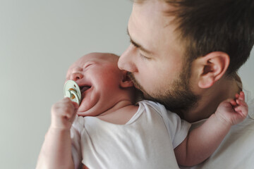 Father holding crying baby
