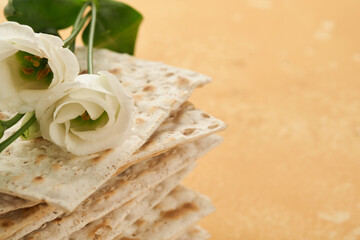 Matzah Passover celebration concept. Traditional ritual Jewish bread on sand color old wall background. Passover food. Pesach Jewish holiday of Passover celebration concept. Passover food.