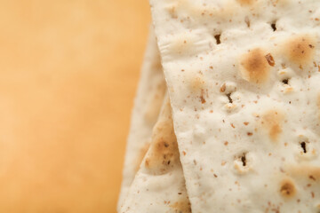 Matzah Passover celebration concept. Traditional ritual Jewish bread on sand color old wall...