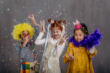 Portrait of three children in funny costumes, studio shoot.