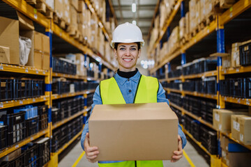 Warehouse female worker checking up stuff in a warehouse.