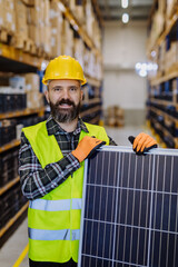 Portrait of warehouse worker with solar panel.