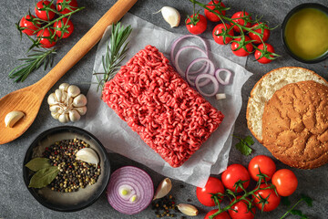 Set raw ingredients for cooking burger on dark background top view