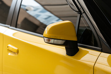 Door mirror, real view mirror of yellow car.