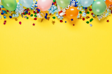 Decoration party on colorful yellow background with copy space top view