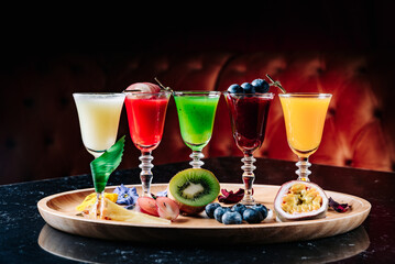 Colourful set of alcoholic cocktails in shot glasses
