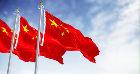 Three flags of China waving on a sunny day