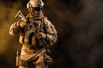 Fototapeta premium Special Forces Military Unit in Full Tactical Gear posing, on a dusty background and smoke, soldier