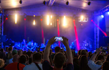 People at concert shooting video or photo