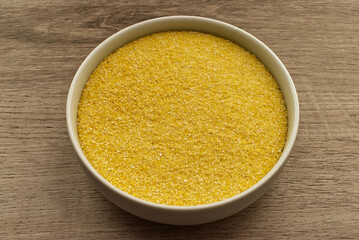 Italian polenta in a bowl isolated on wooden background.