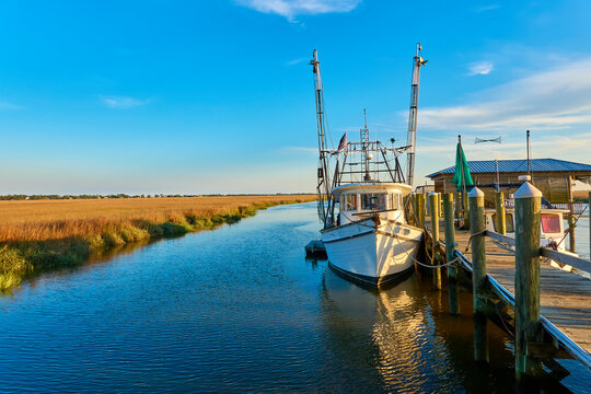 Sunset with shrimp boat along a dock at Tybee Island, Ga.