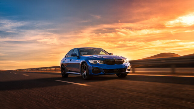 Seattle, Washington, USA March 31, 2023 blue BMW 320 with M Performance package. a car on the road at sunset. The 3 Series is BMW's best-selling model. Sports car concept