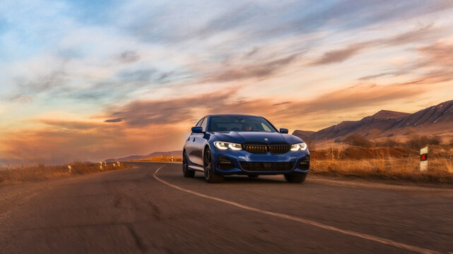 Seattle, Washington, USA March 31, 2023 blue BMW 320 with M3 Performance package. the car is on the road.