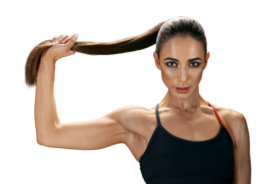 Muscular young female athlete holds her hair in a ponytail. Confident look into the camera. Muscular woman's arm.
