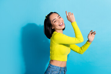 Profile portrait of cheerful nice lady closed eyes enjoy dancing music isolated on blue color background