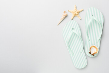 Striped flip flops on color background, top view