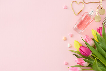Women's Day concept. Top view photo of bunch of colorful tulips perfume bottle bijouterie earrings and hearts baubles on pastel pink background with copy space