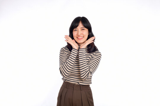 Happy young asian woman, professional entrepreneur standing in casual clothing, open mouths raising hands shout announcement, white background