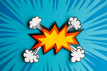Empty speech bubble for your design. Handmade cut out paper craft art work on blue background. Pop art and comic style. 