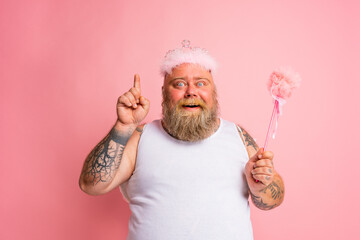 Fat man with tattoos and beard acts like a magic fairy